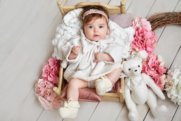 Baby girl with flowers and toys Postcard Mother's Day and Easter Children Protection Day World Happiness Day Smiling child