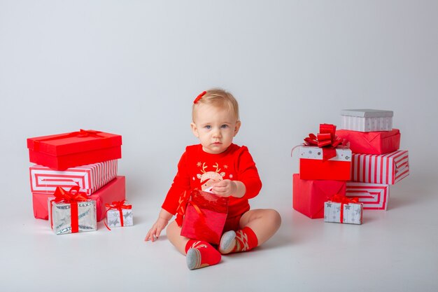 Baby girl with gifts on a white background isolated christmas new year