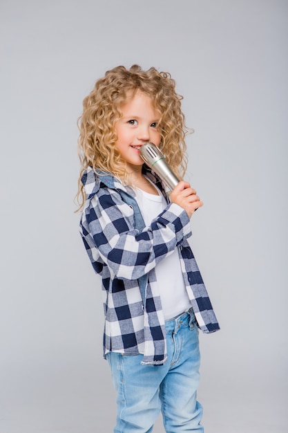 baby girl with microphone smiling singing