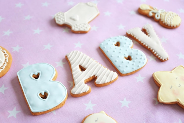 Baby glazed cookies on decorated table