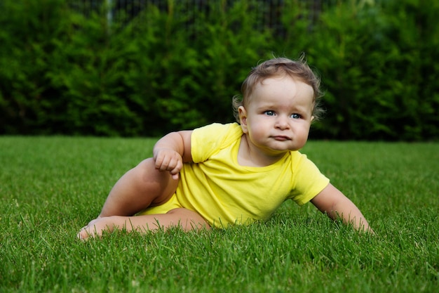 Baby on green grass.