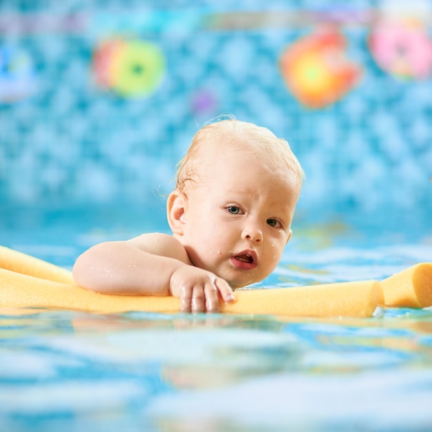 Baby having fun in the swimming pool