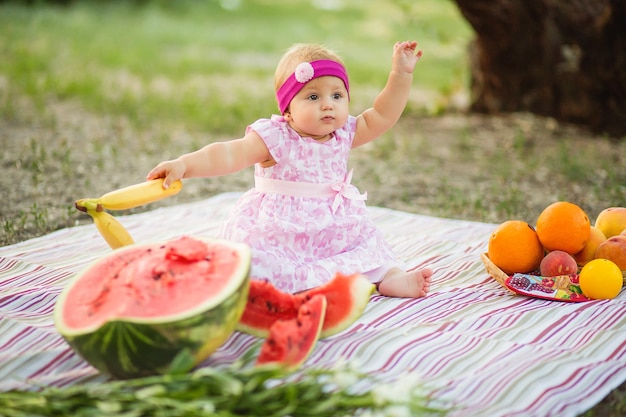 Baby having a picnic in the summer park