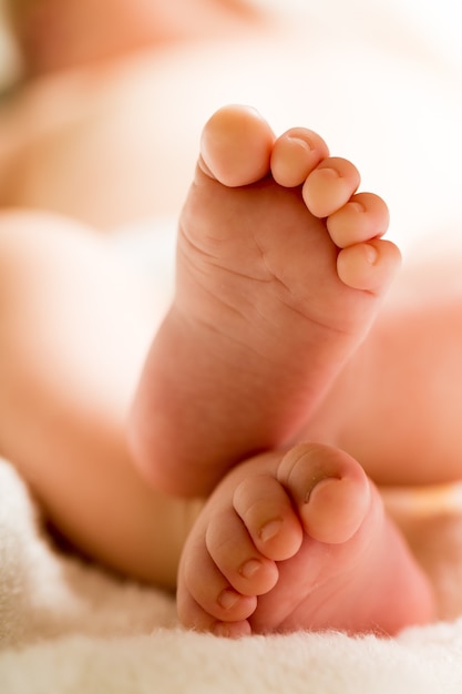 Baby human foot newborn close to moving up closed human toe