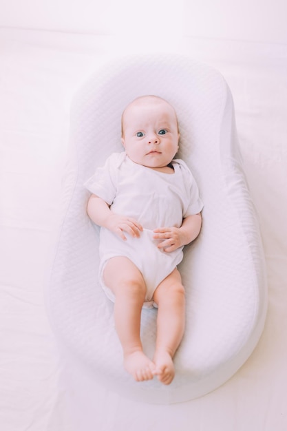 The baby is lying in a cocoon of copy space The baby is 03 months old