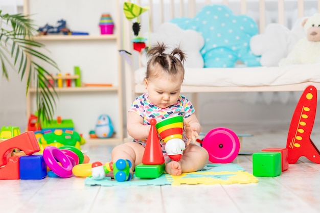 The baby is playing at home in the nursery Toys for small children A child with educational toys Early development