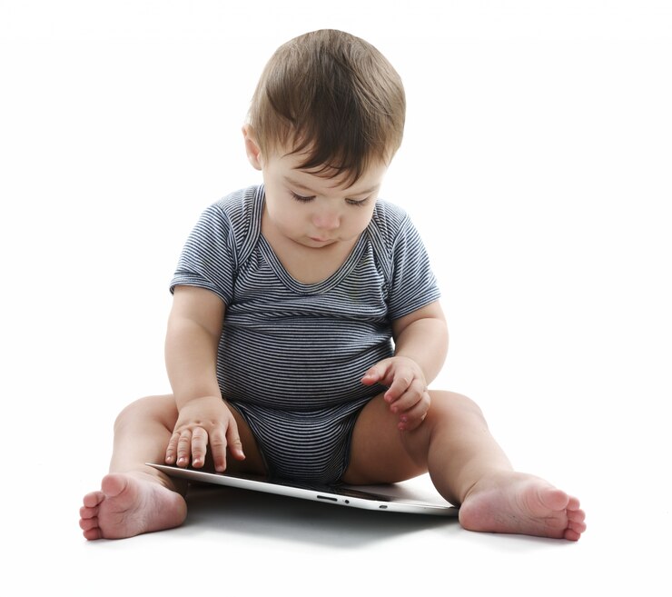 Baby is sitting on floor, isolated on white