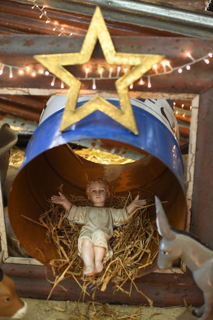 Baby Jesus laying in a straw cradle