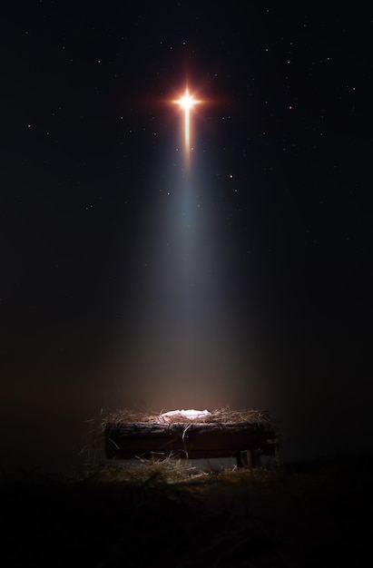 Photo baby jesus in a manger with bright big star cross and light shining on it and christmas background