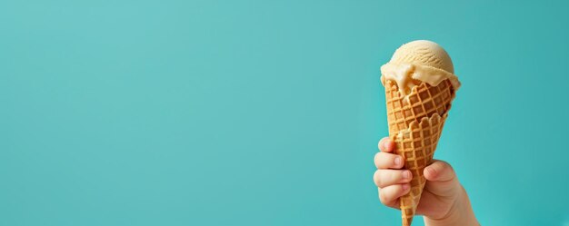 Foto bambino con la mano che tiene un grande gelato in waffle con sullo sfondo blu