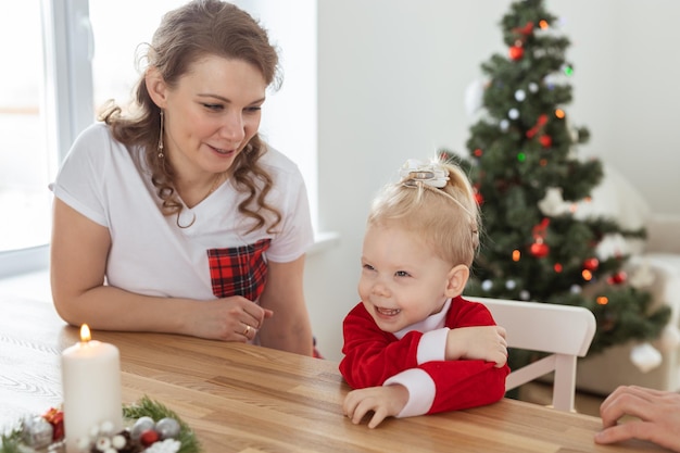 Baby kind met gehoorapparaat en cochleair implantaat plezier met ouders in kerstkamer dove div