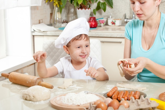 baby knead the dough in flour