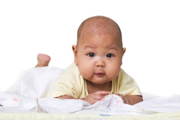 Baby laying down on bed. 