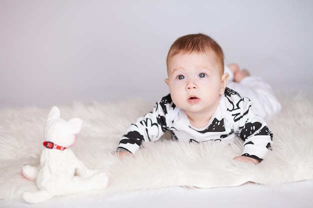 baby lies on his stomach on the mat