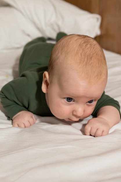 baby lies on tummy and learns to crawl