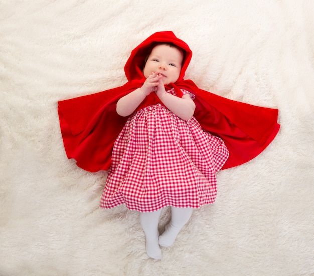 Baby Little Red Riding Hood on white fur