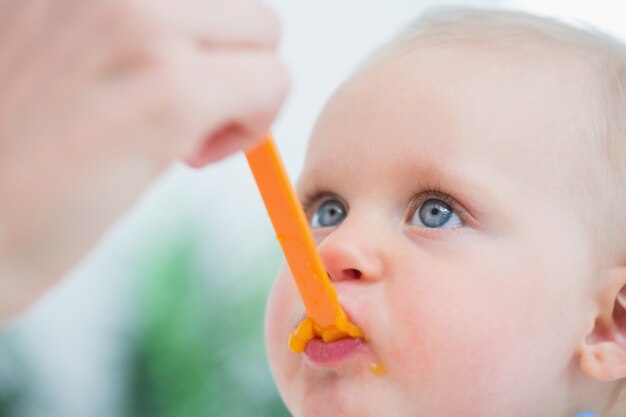 Baby looking at his mother while eating