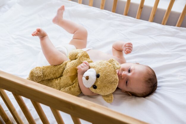 Baby lying on baby bed