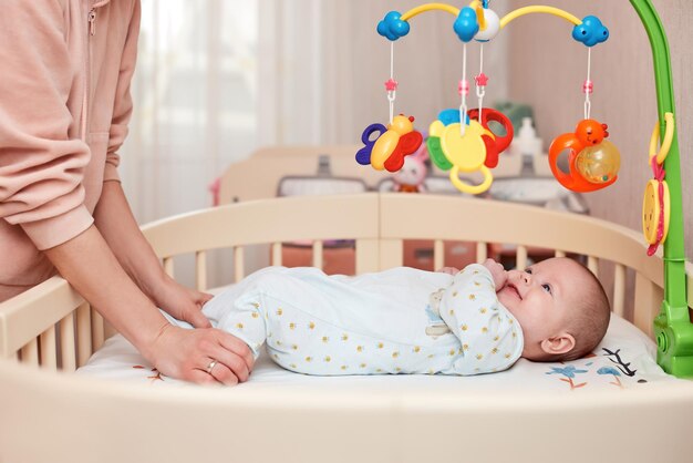 Baby massage mother doing gymnastics with newborn child