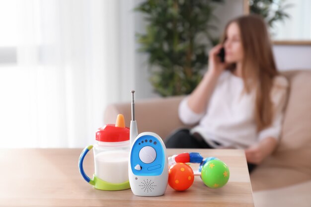 Photo baby monitor, different accessories and woman on . radio nanny