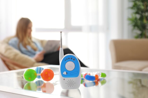 Baby monitor, different accessories and woman on . Radio nanny