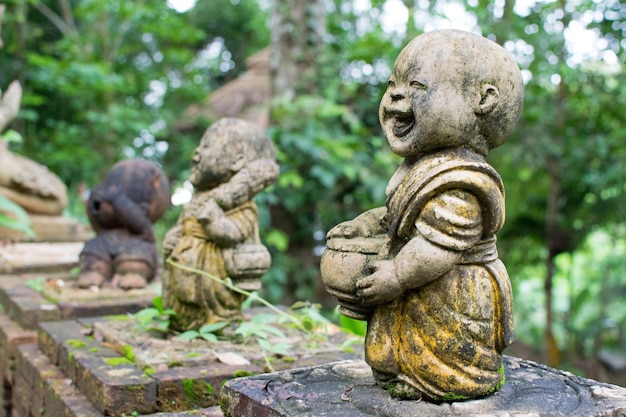 Baby monk ancient statue in temple of thailand