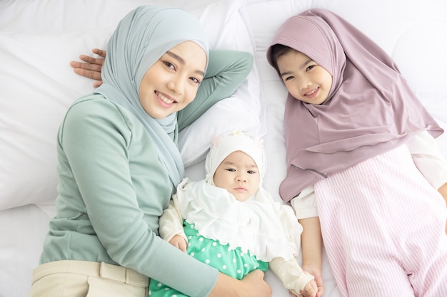 Baby And Mother At Home In Bed, Happy loving family