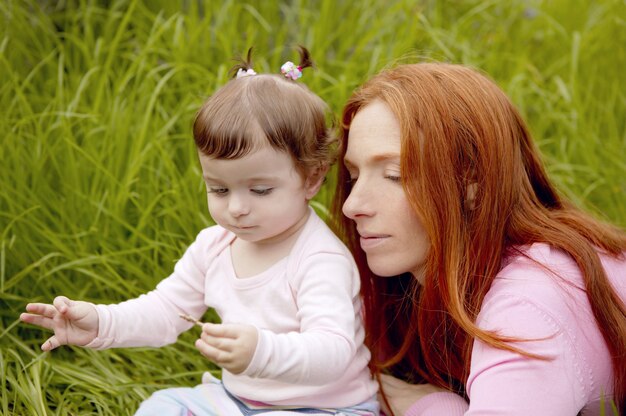 Baby and mother outdoor grass playing park