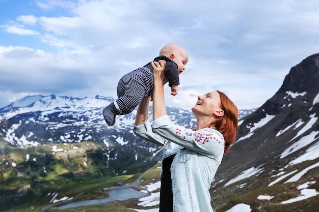 Baby and mother with the Alps mountains in nature in the Background