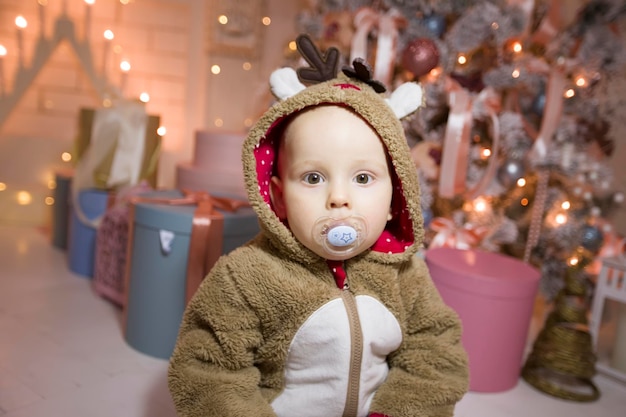 Baby in a New Year's costume with a dummy