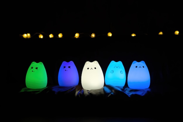 Baby night lamp five nightlights in a row different colors on\
the couch white lamp in foreground