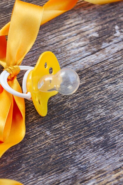 Baby pacifier on wooden table