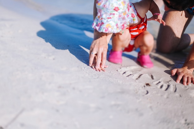 baby playing at the beach