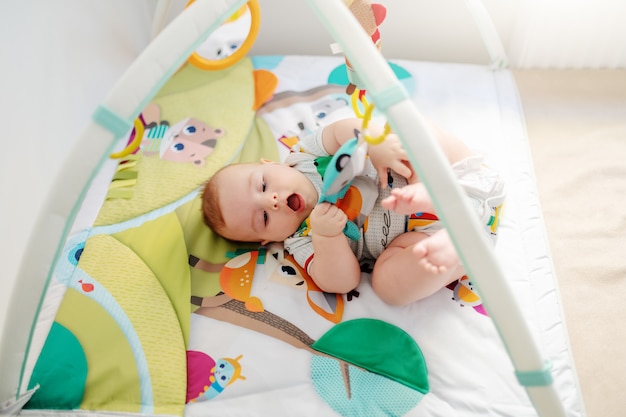 Baby playing in crib.