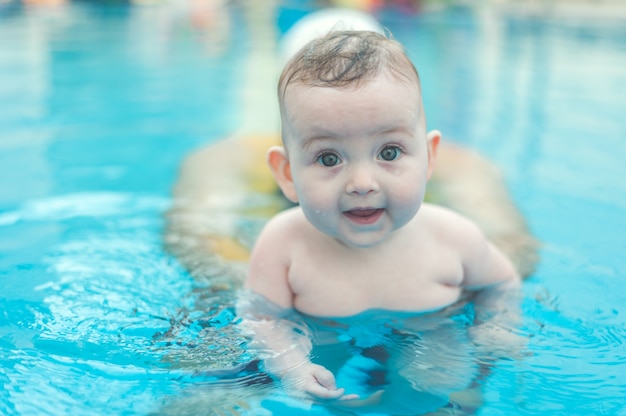 Baby playing in swimming pool