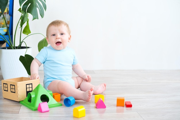 Baby playing with colorful blocks on the floor