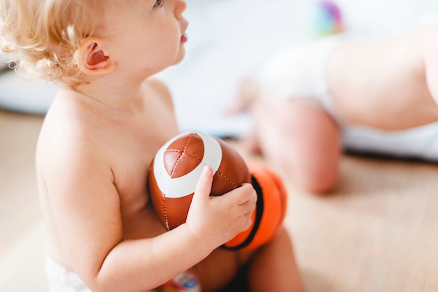 Baby playing with sports balls