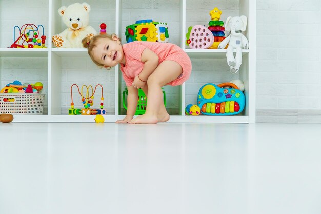 Baby plays with toys in her room Selective focus Child