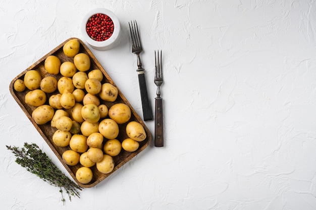 Baby potato set on white stone table background top view flat lay with copy space for text