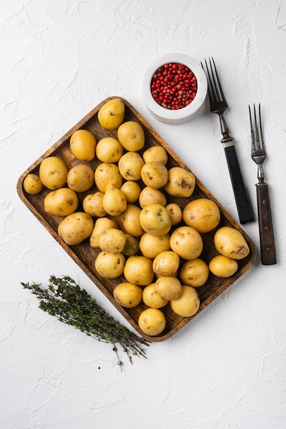 Baby potato set on white stone table background top view flat lay