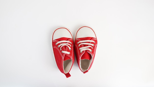 Baby red sneakers isolated on white background. 