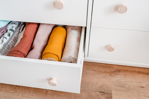 Baby's clothes neatly laid out in the chest of drawers Organization of the children's closet