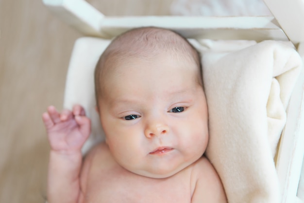 baby's face with hand near the face close-up.