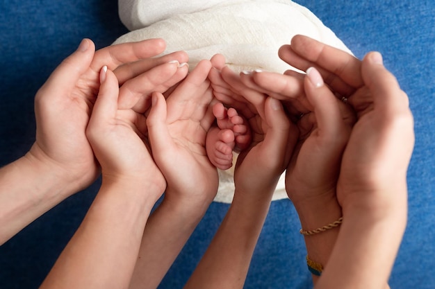 baby's feet in the hands of the older child and mom