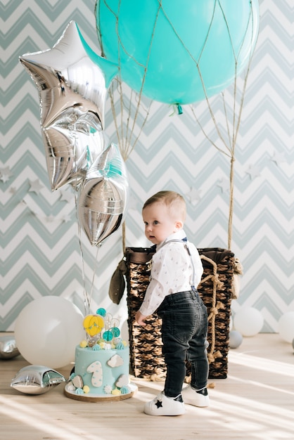 Baby's first birthday. Cute smiling baby is 1 year old. The concept of a children's party with balloons