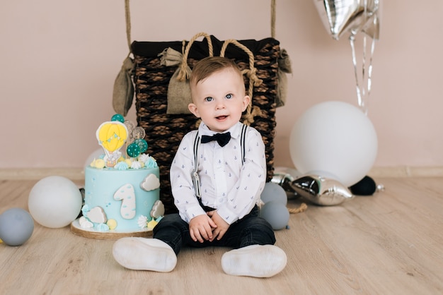 Baby's first birthday. Cute smiling baby is 1 year old. The concept of a children's party with balloons