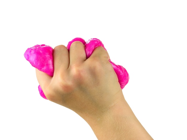 Baby's right hand strongly squeezes red slime isolated on white surface. Toy antistress. Toy for the development of hand motor skills.