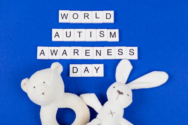 Baby's toys with inscription World Autism Awareness Day