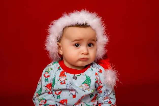 baby Santa on red background, space for text