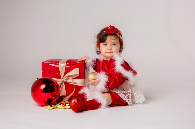 baby Santa with gift box on white